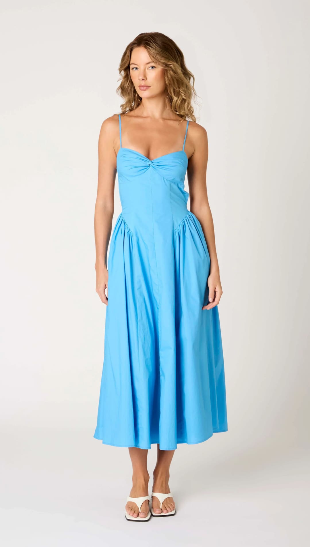 Blue sundress with spaghetti straps.