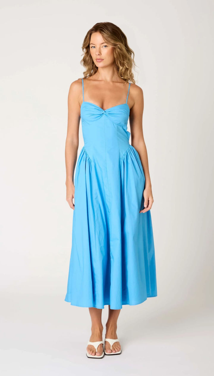 Blue sundress with spaghetti straps.