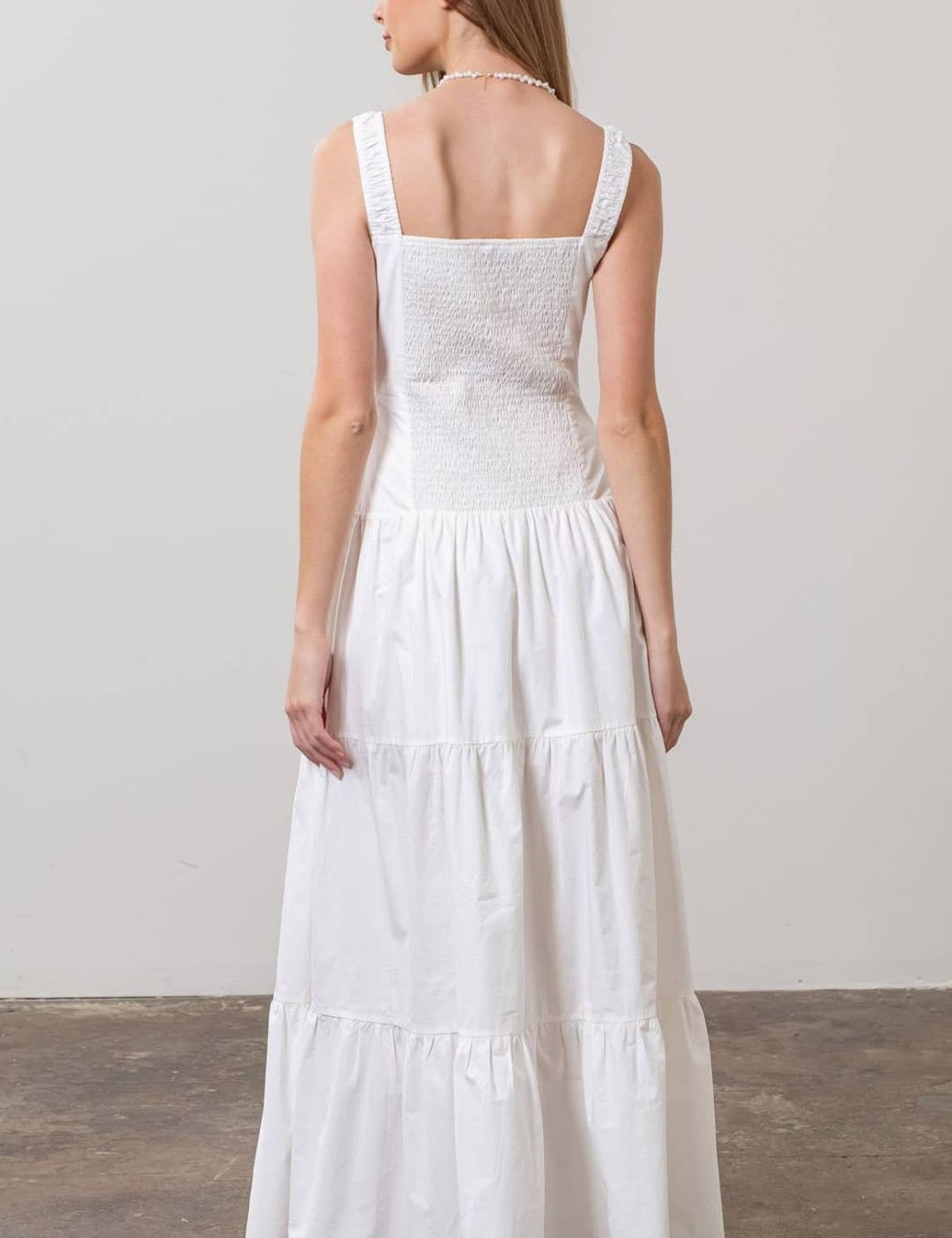White embroidered tiered maxi dress with square neckline and thin straps