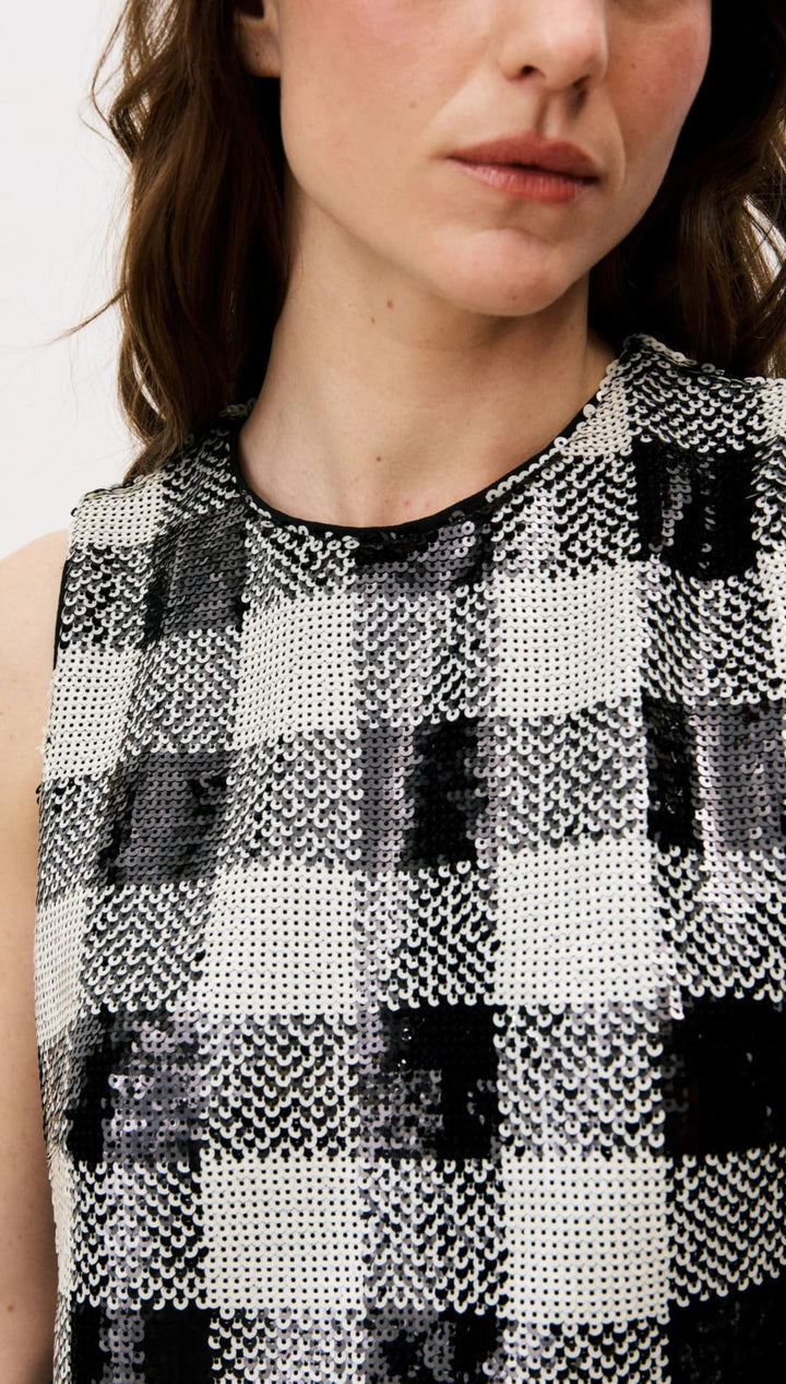 Black and white checkered sleeveless top with textured fabric.