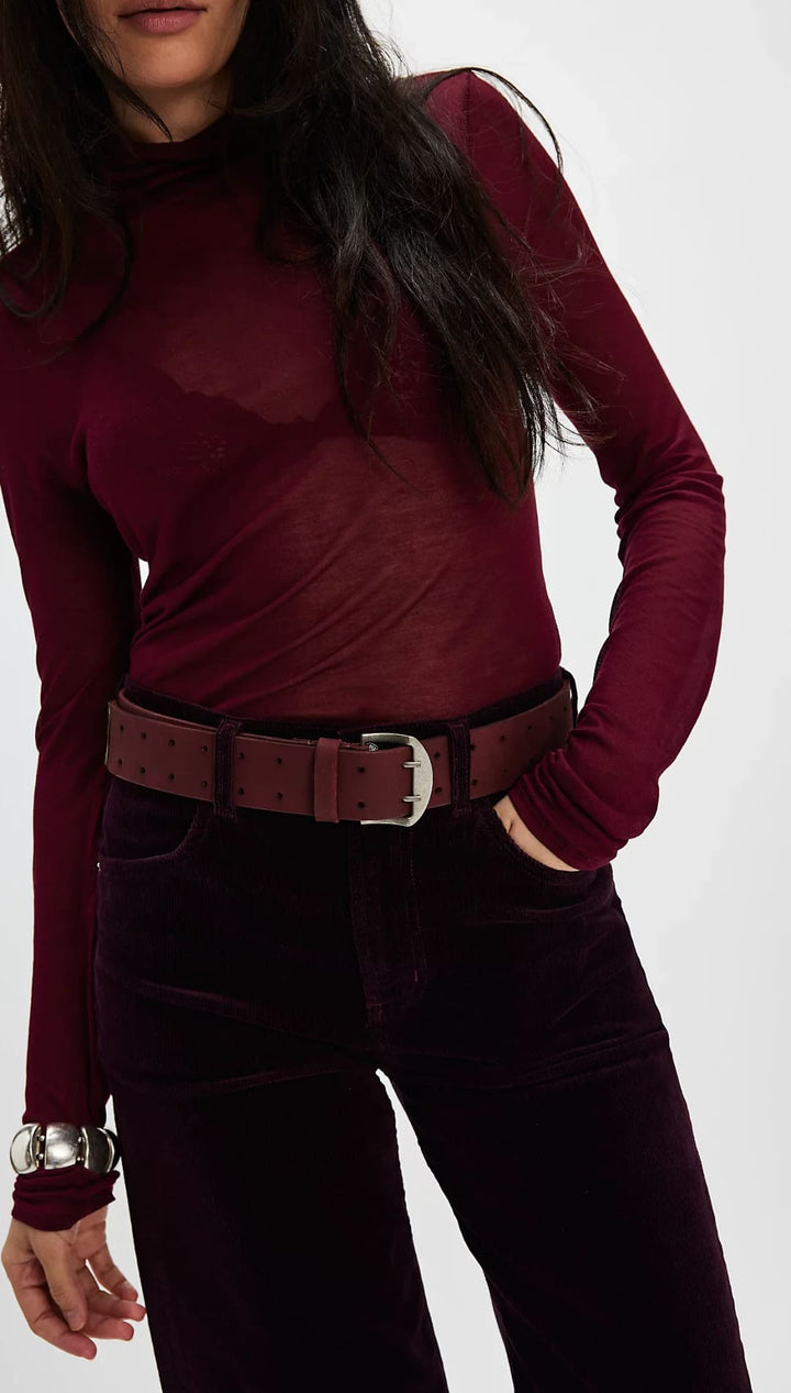 Burgundy turtleneck and velvet pants.