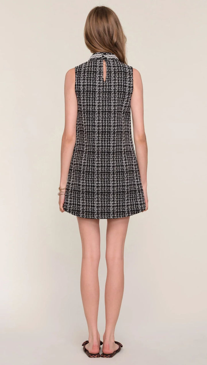 Tweed sleeveless mini dress with a plaid pattern and button detail at the back.
