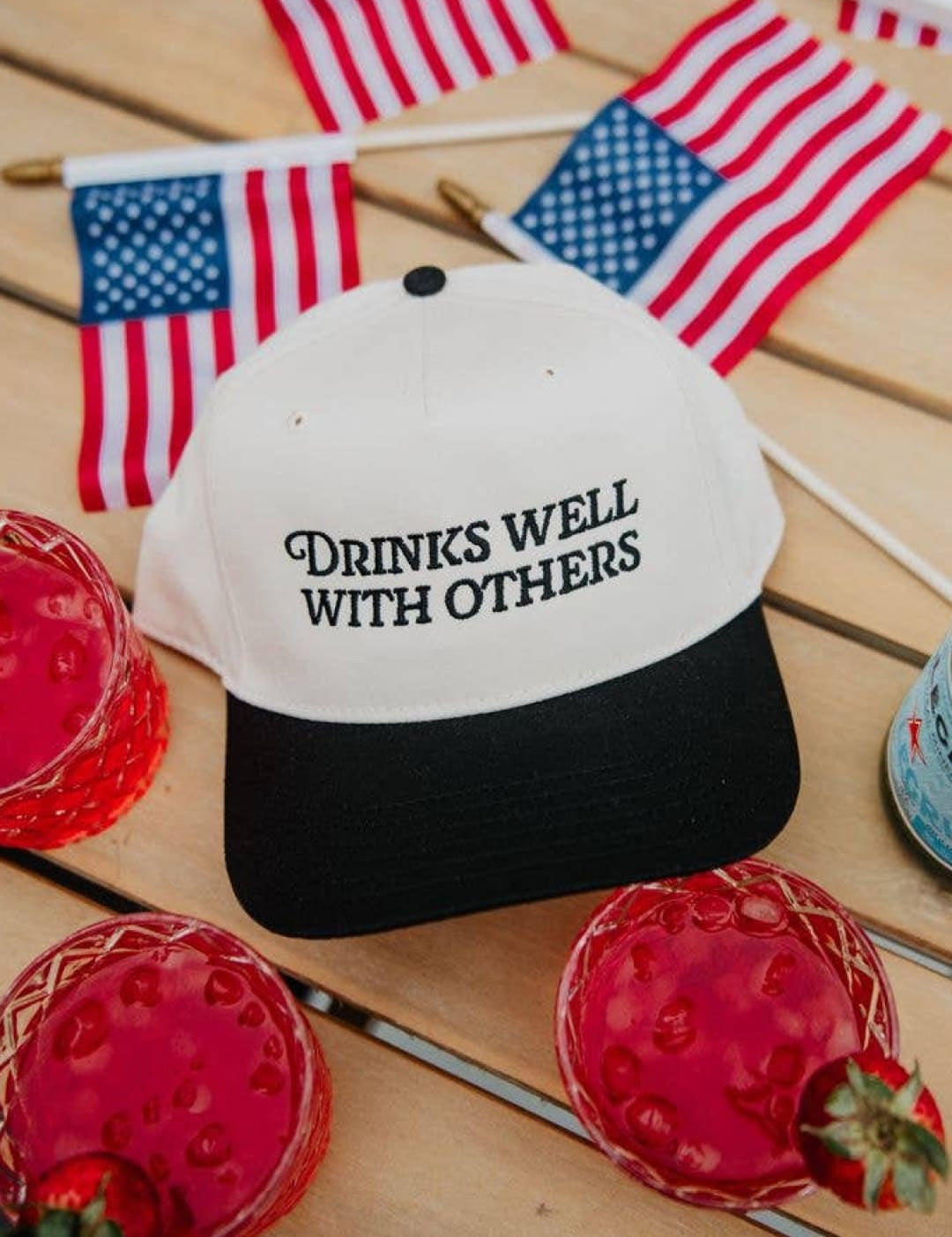 4th of july patriotic baseball cap with ’drinks well with others’ text.