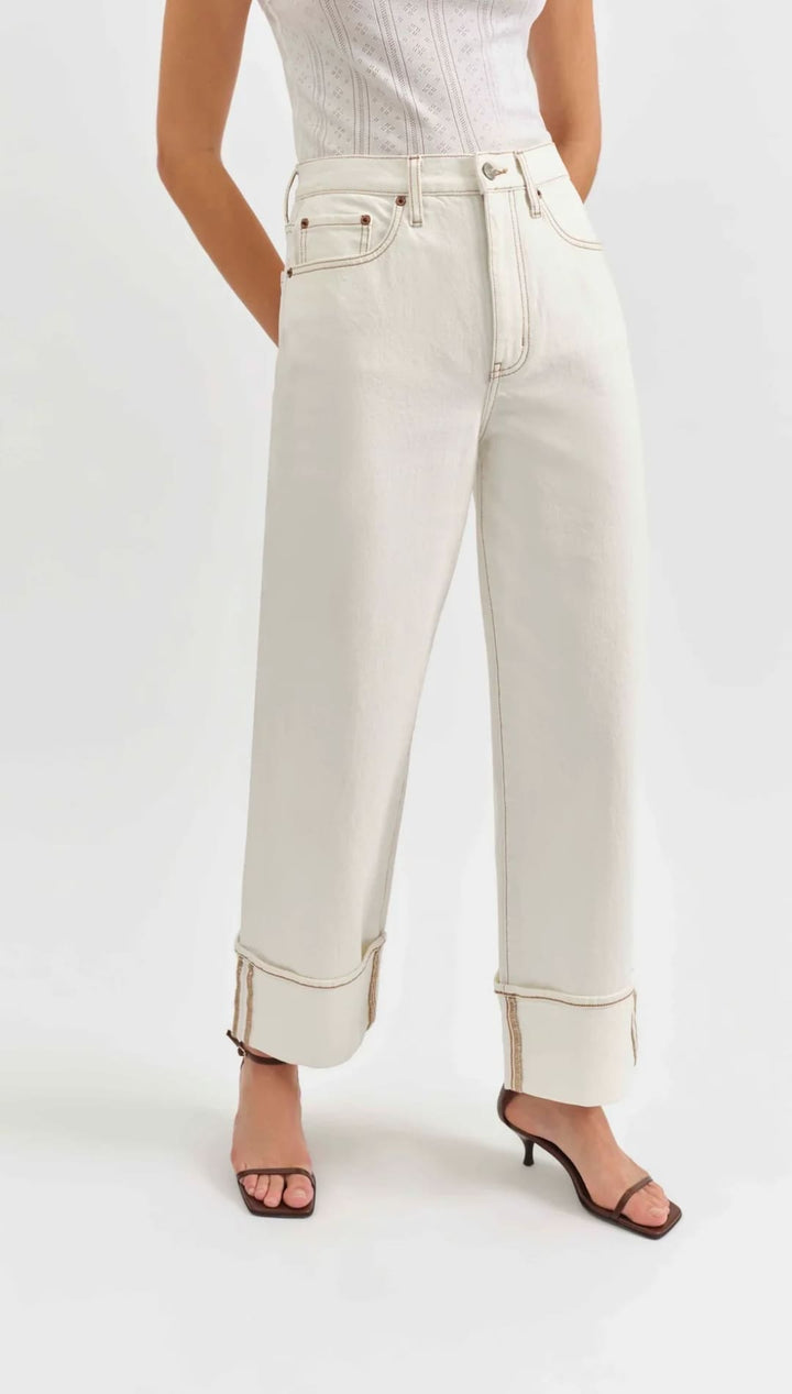 White straight-leg jeans with rolled cuffs.