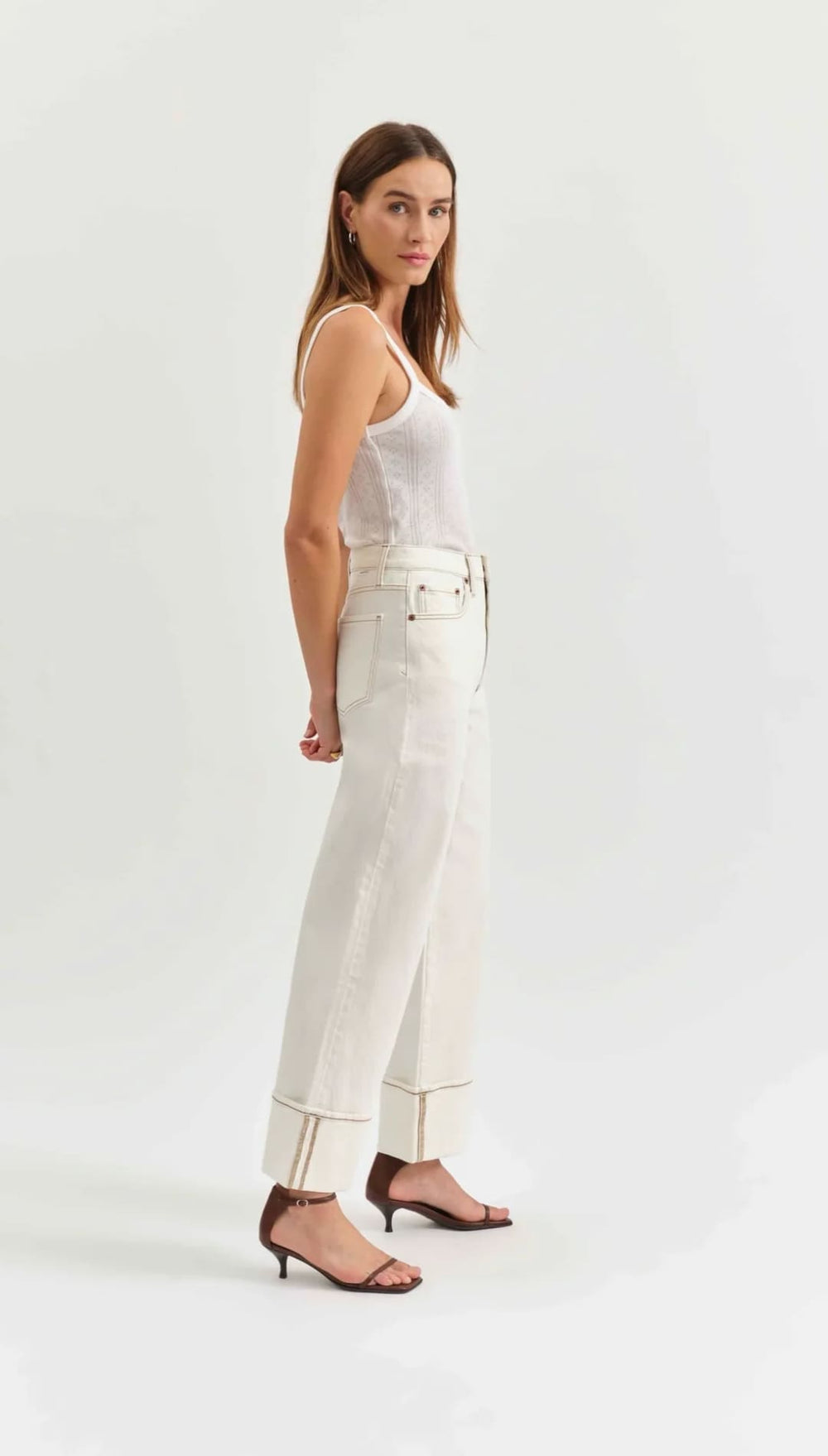 White straight-leg jeans with visible seam details and a high waist.