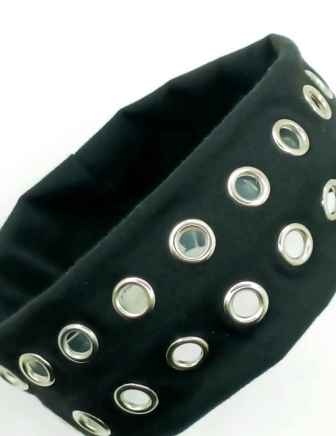 Black studded headband with silver eyelets and elastic band.