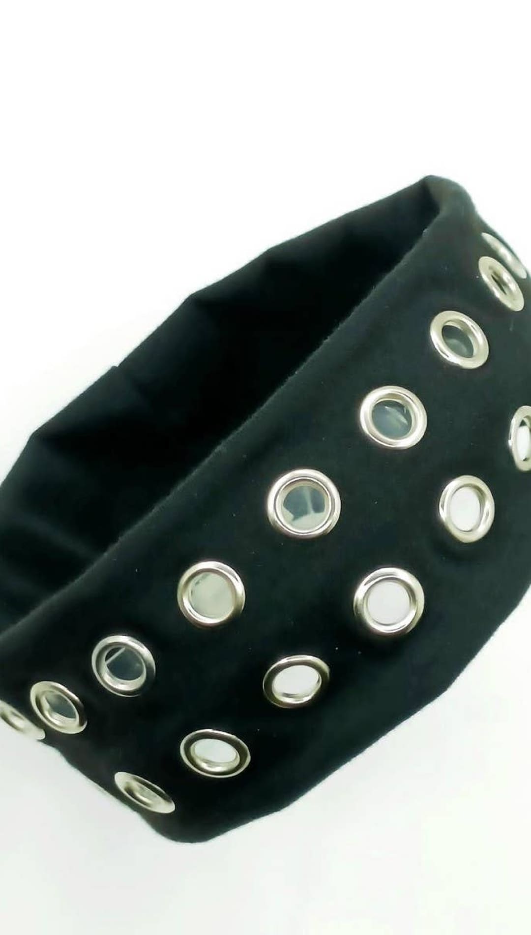 Black studded headband with silver eyelets and elastic band.