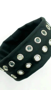 Black studded headband with silver eyelets and elastic band.