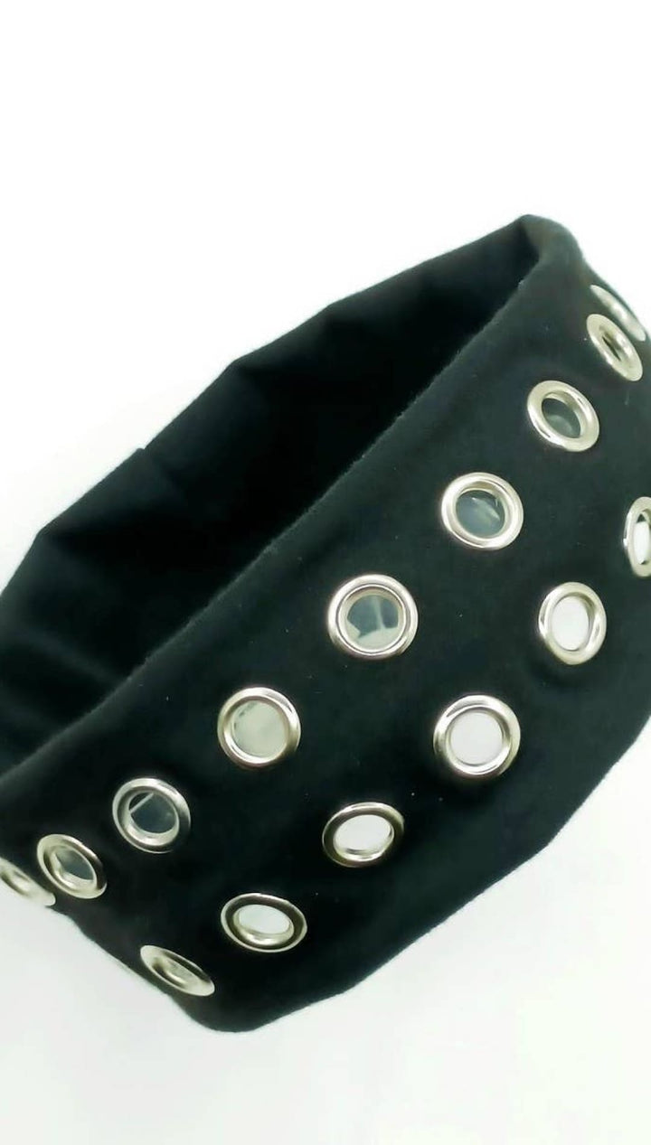 Black studded headband with silver eyelets and elastic band.