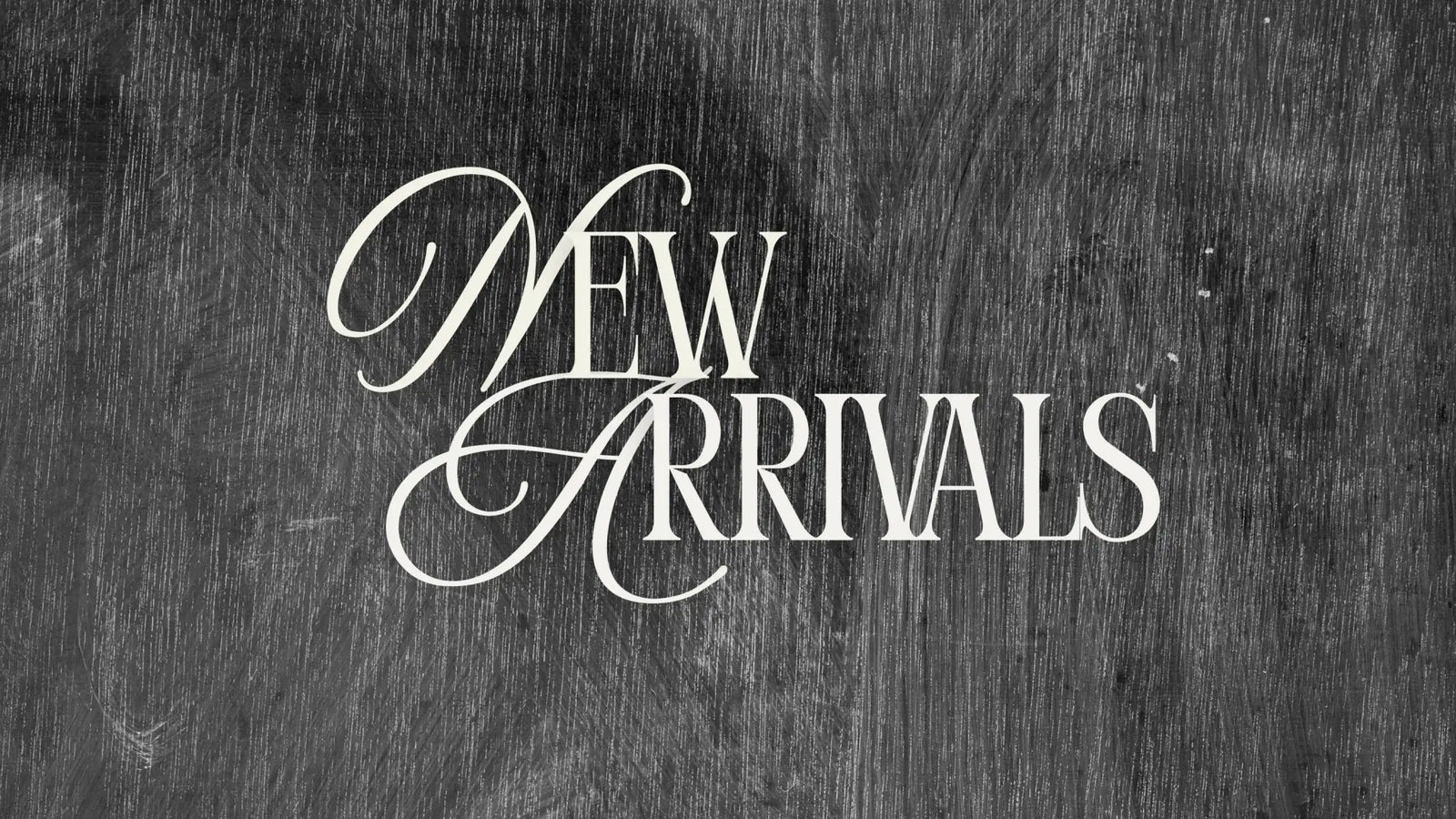 Elegant white cursive ’new arrivals’ text on a textured dark gray chalkboard background.