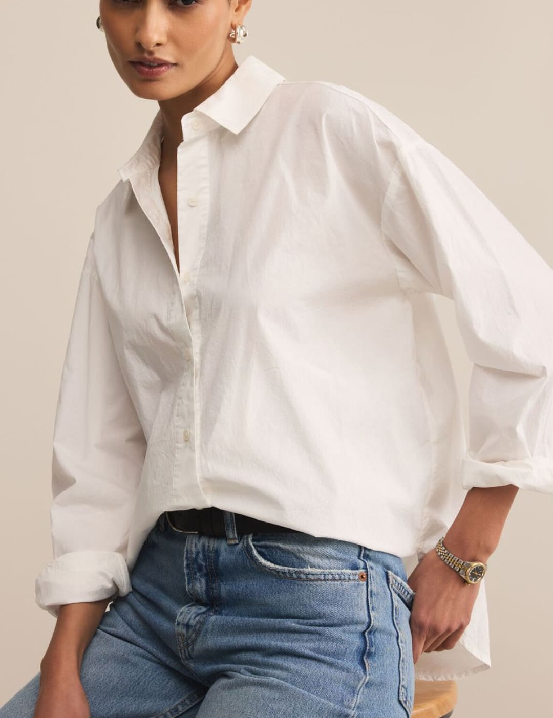 White oversized poplin shirt with balloon sleeves and button-down collar.