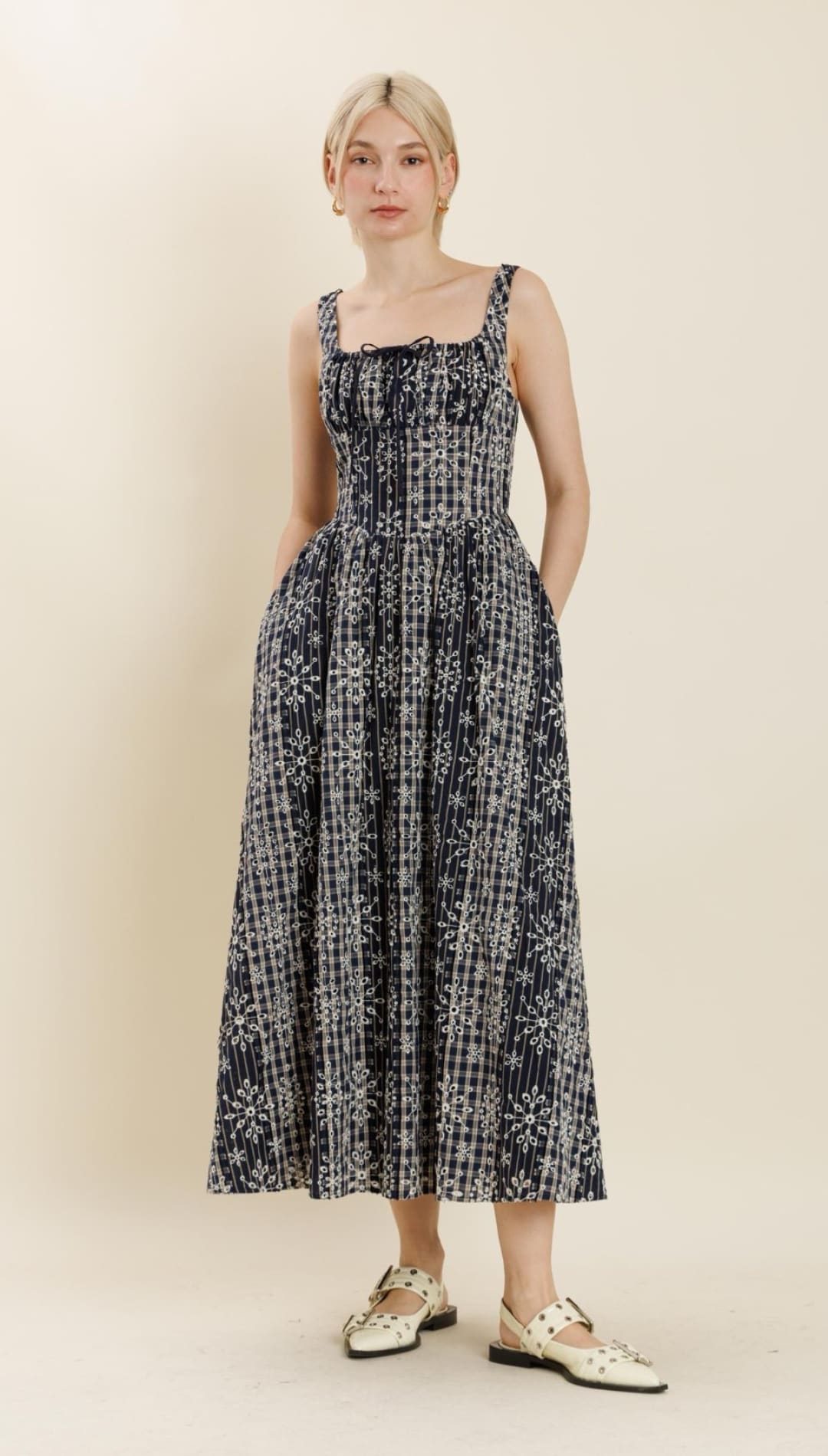 A black midi sundress with white floral and striped patterns, square neckline, and thick shoulder straps.