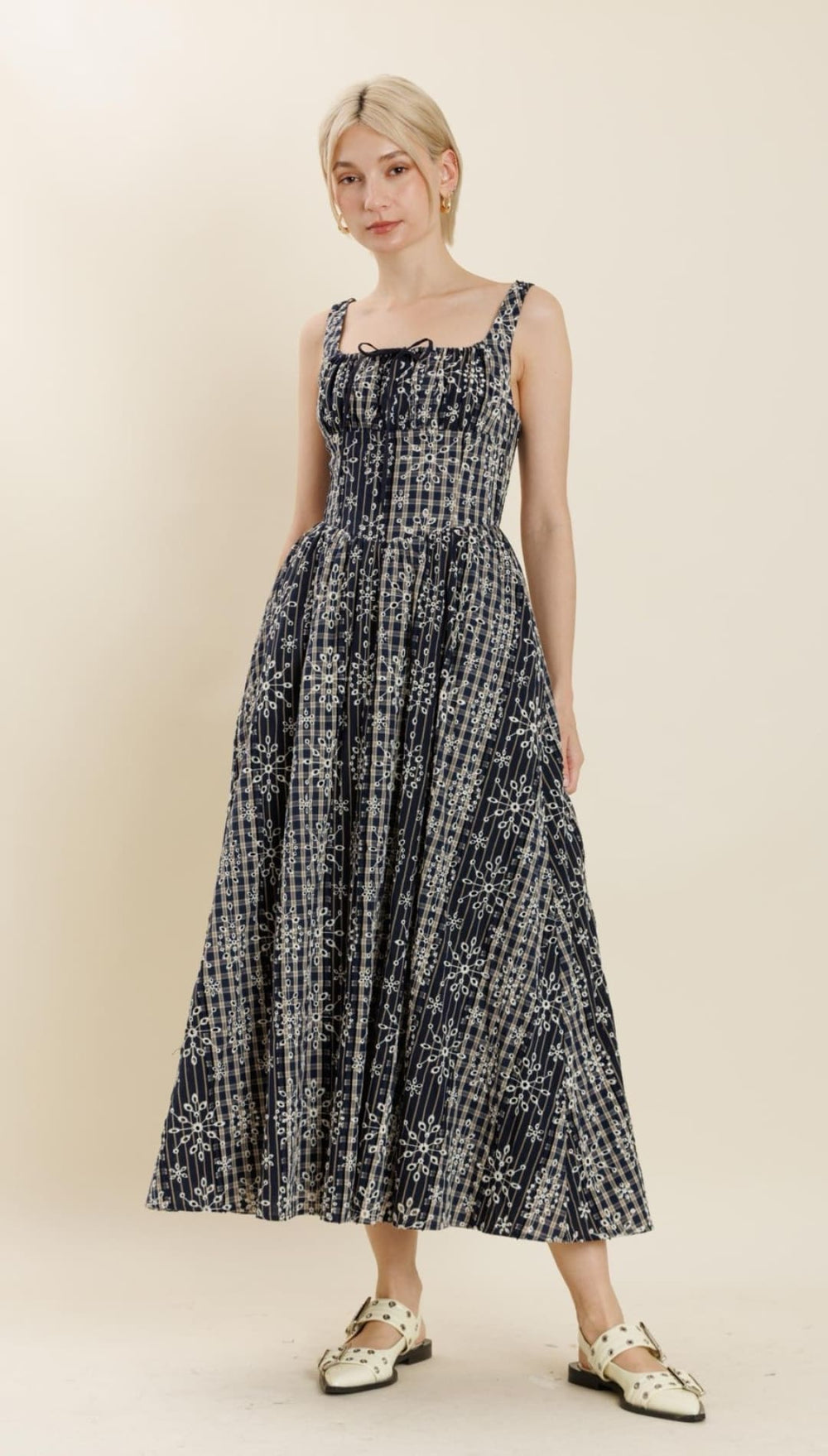 Black and white patterned midi dress with a square neckline and tie details.