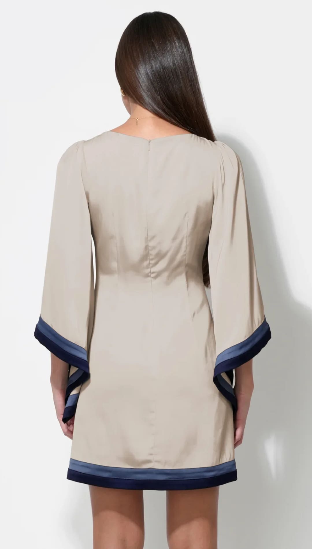Beige and navy blue dress with bell sleeves.