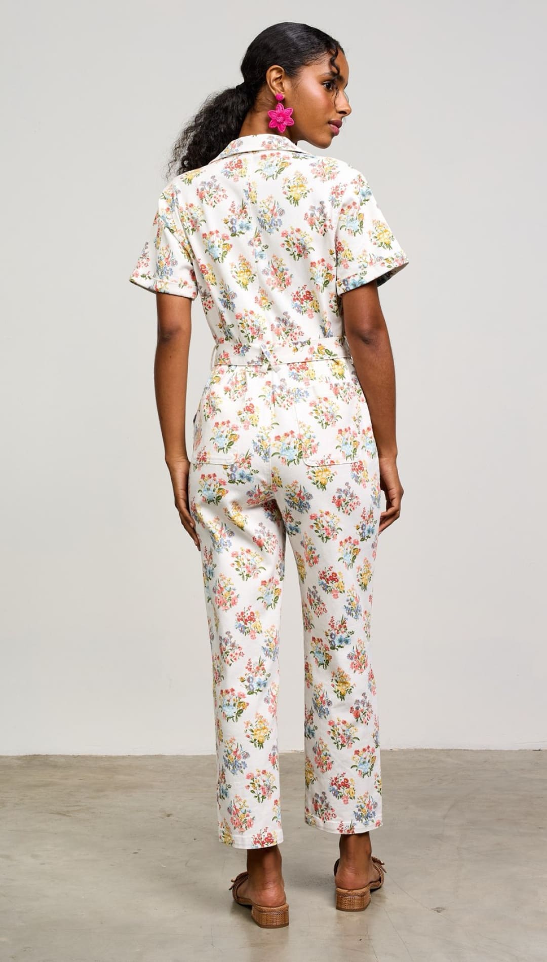 Floral print jumpsuit with short sleeves and straight-leg pants.