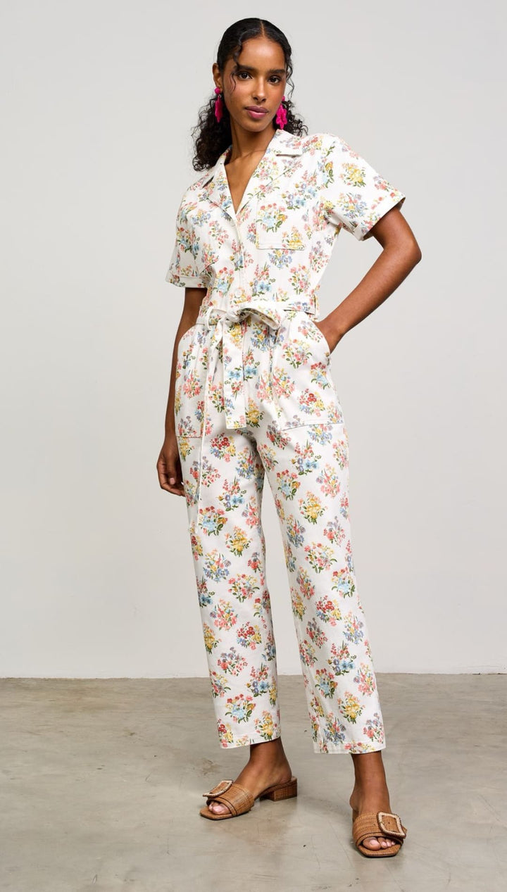 Floral print jumpsuit with short sleeves, collared neckline, and ankle-length pants.