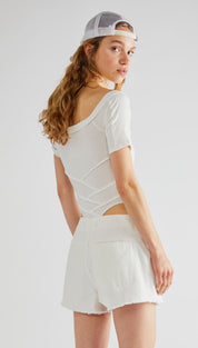 White short-sleeved top with a back cutout and geometric paneling
