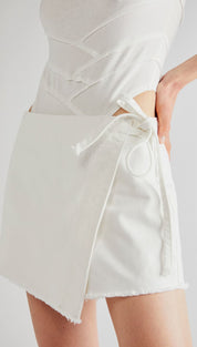 White wrap-style mini skirt with a frayed hem and matching drawstring tie.