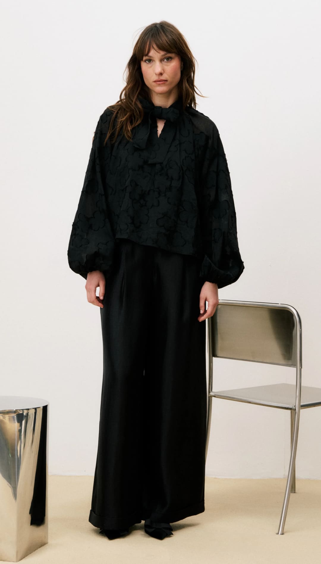 Black oversized shirt dress with wide sleeves and high-low hem.
