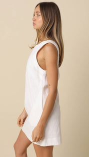 White sleeveless linen dress with a relaxed fit and subtle side slit
