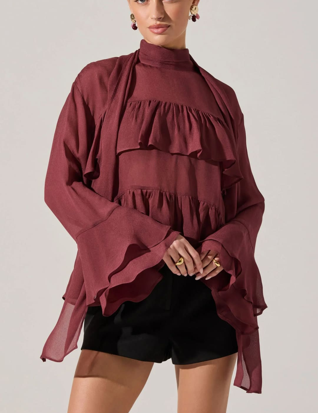 Women’s tiered ruffle blouse with bell sleeves.