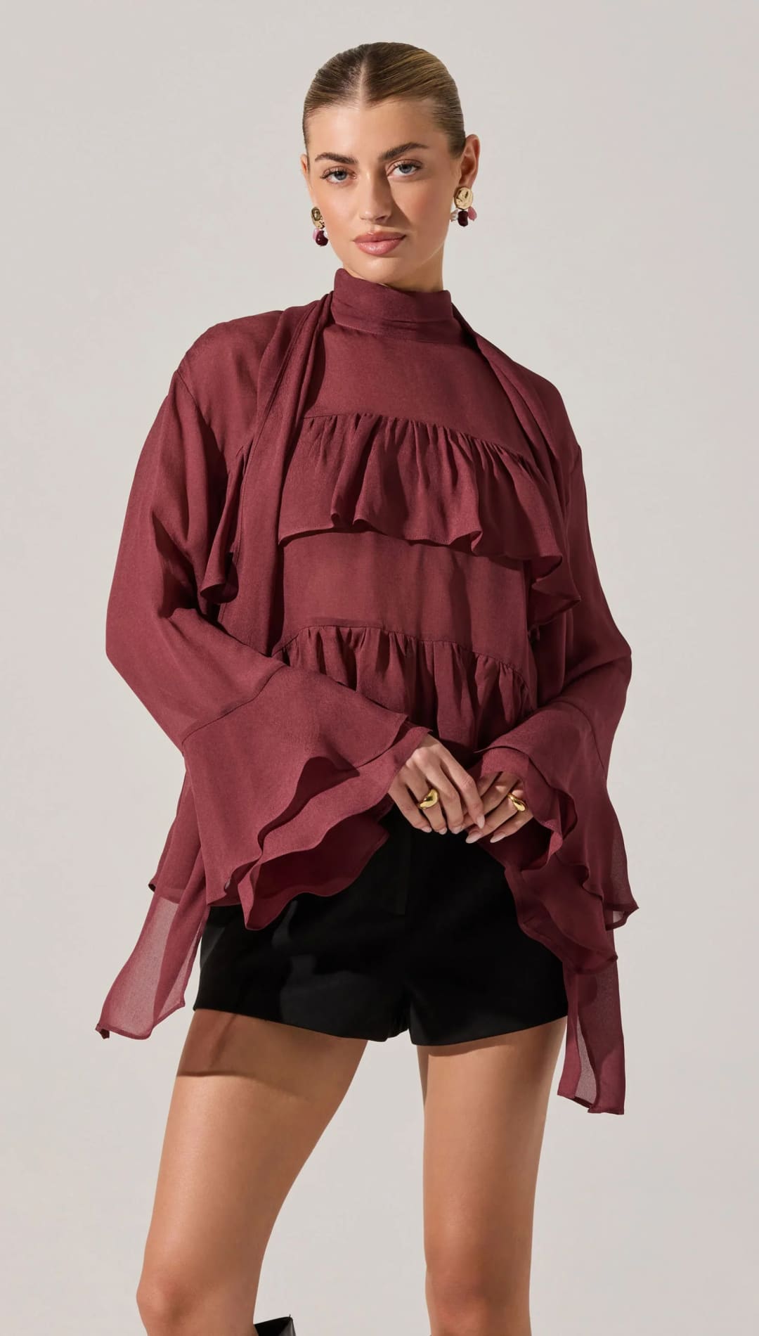 Women’s tiered ruffle blouse with bell sleeves.