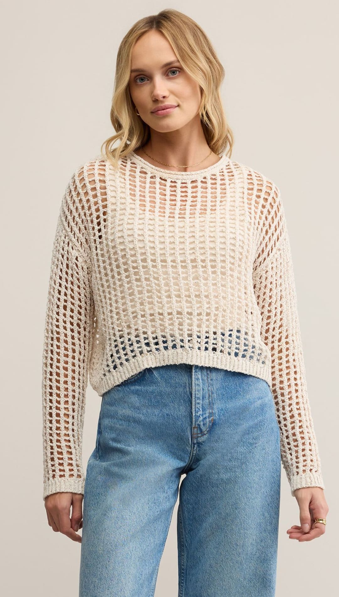 Cream-colored open-knit long-sleeve sweater.