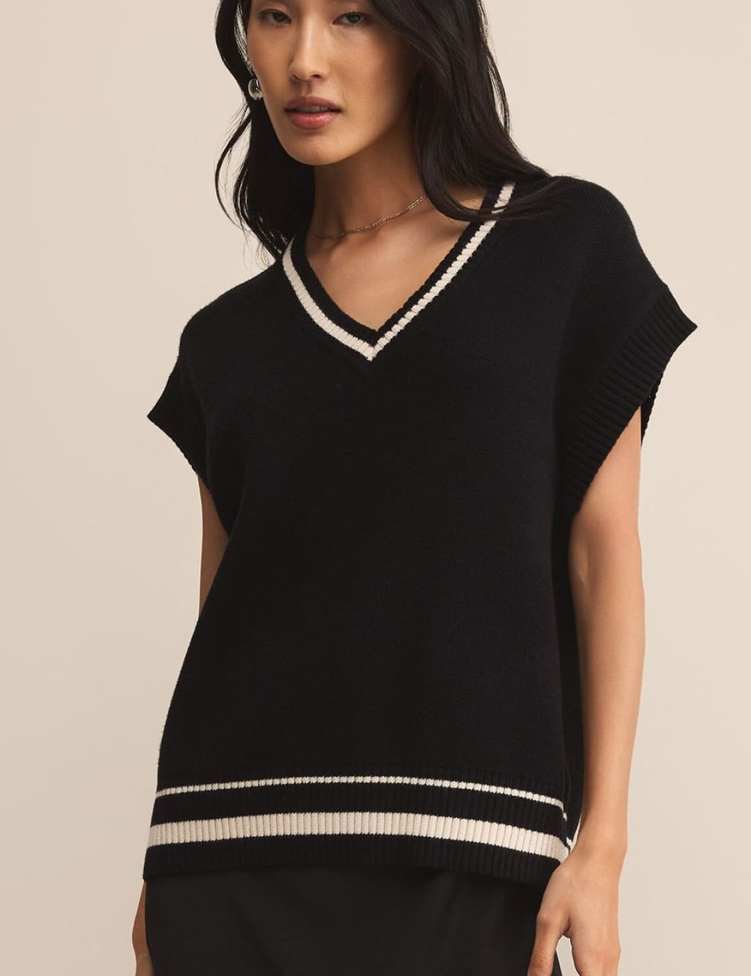 Black and white striped knit top with short sleeves.