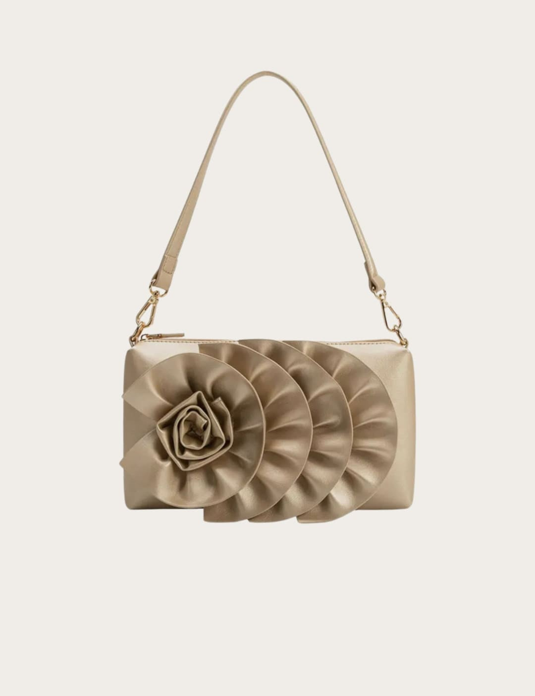 Gold-toned handbag with floral embellishment.