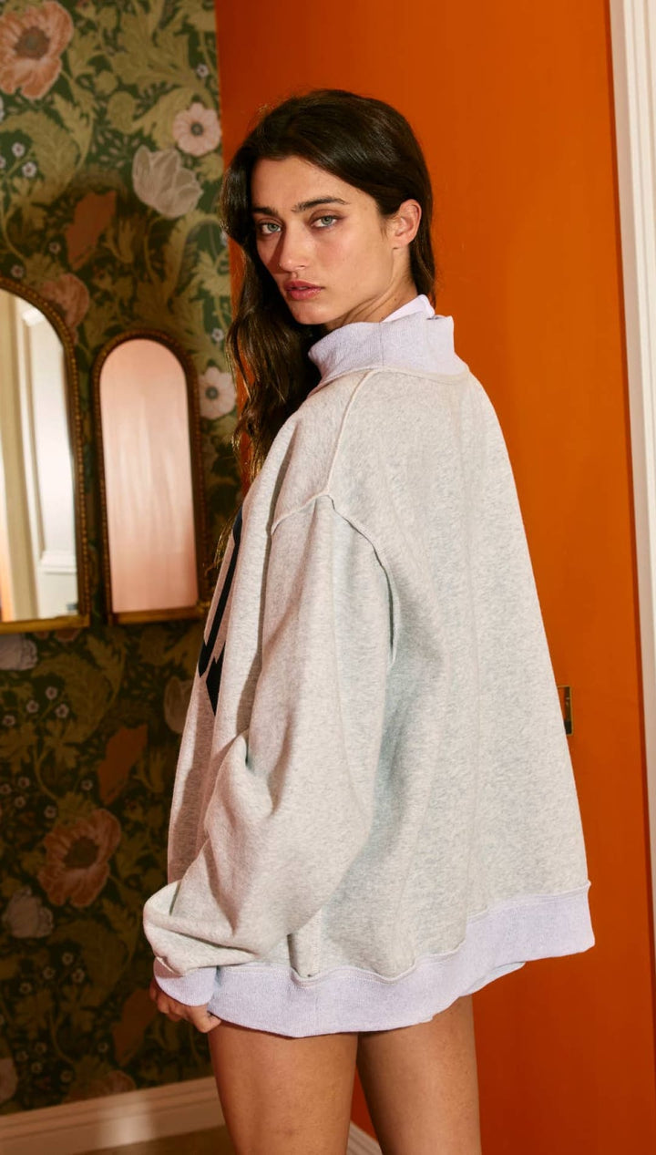 Light blue oversized denim jacket with white stitching and pockets.