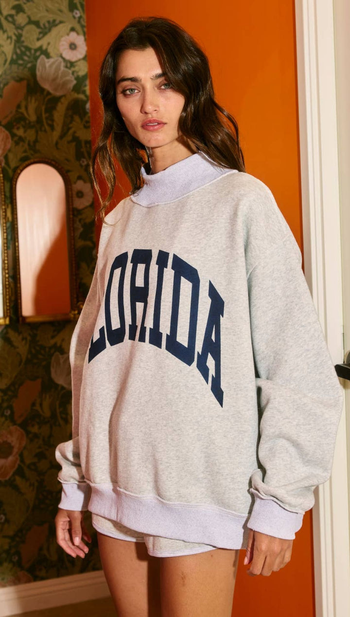 Florida sweatshirt with navy blue lettering and distressed texture.