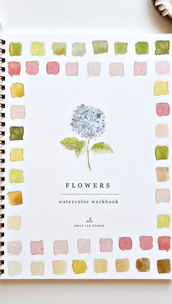 Watercolor workbook featuring a blue hydrangea illustration and pastel color palette with spiral binding.