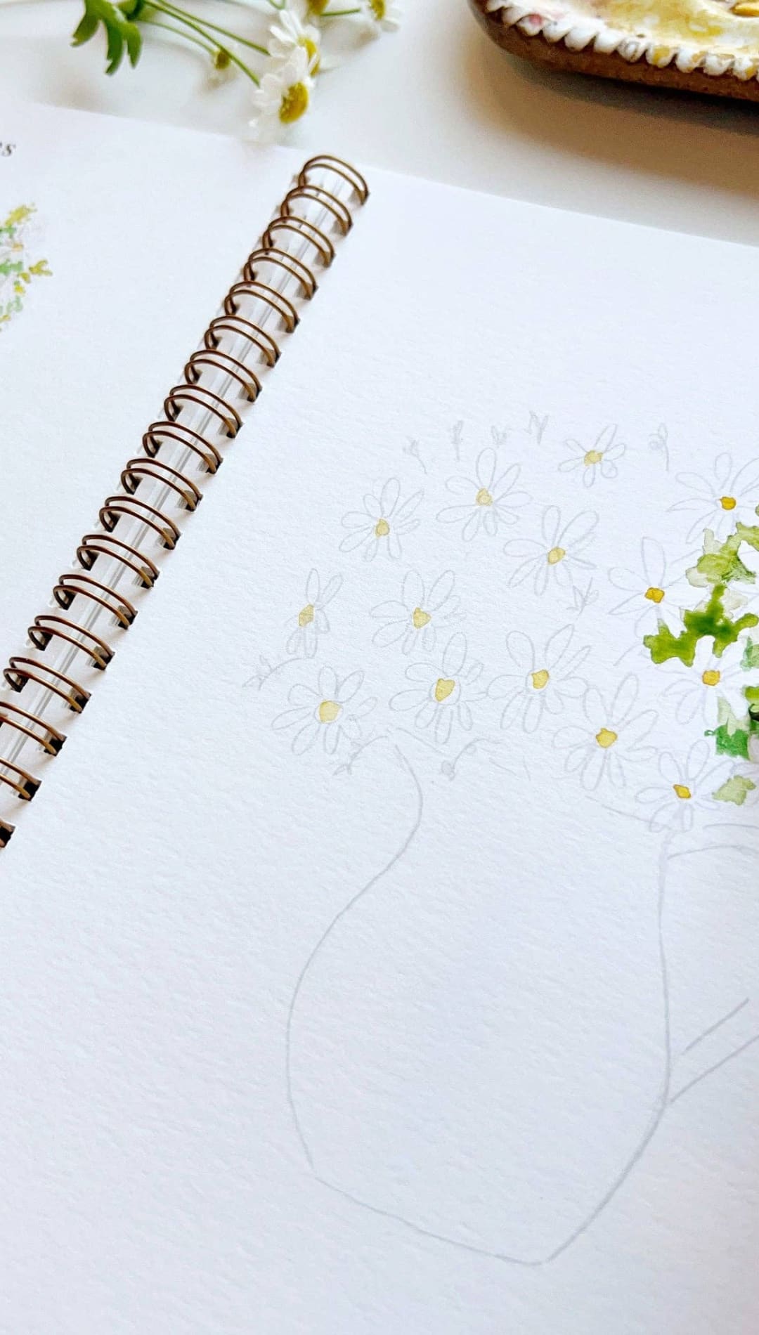 Watercolor paintbrush with red handle and silver ferrule, designed for detailed brushwork.