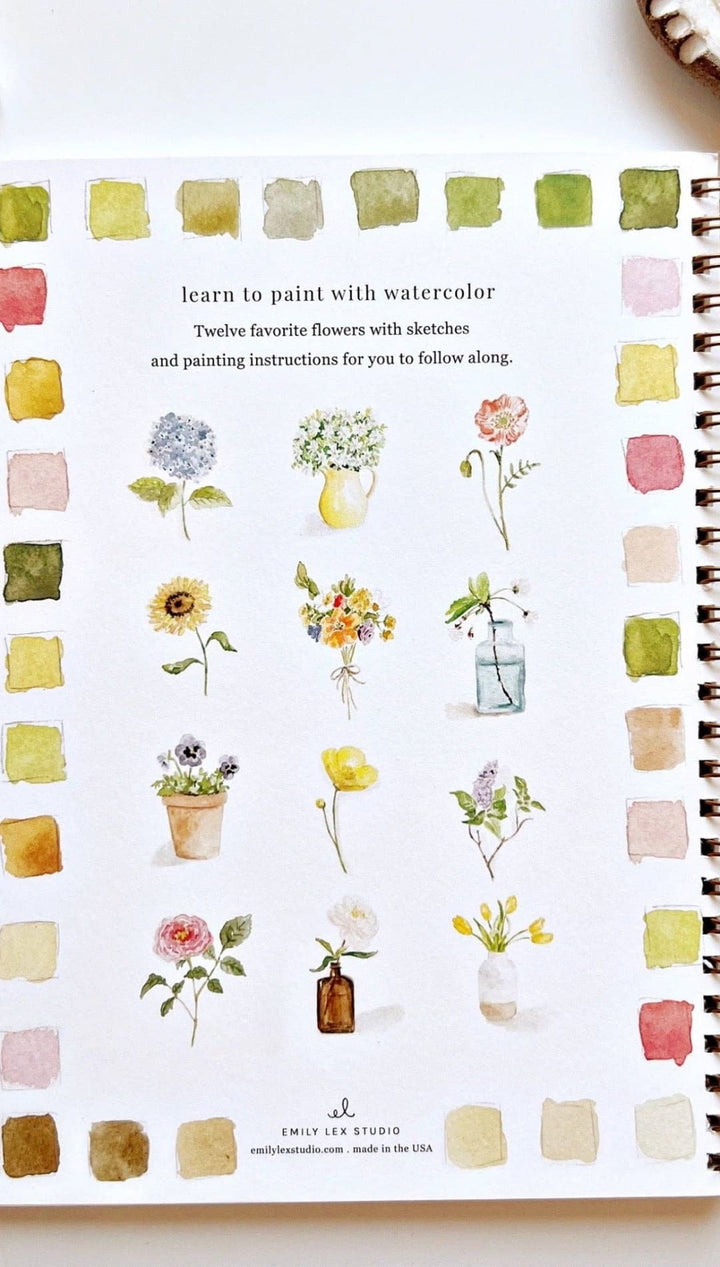 Watercolor painting book with floral designs and color swatches, spiral-bound cover in white paper.