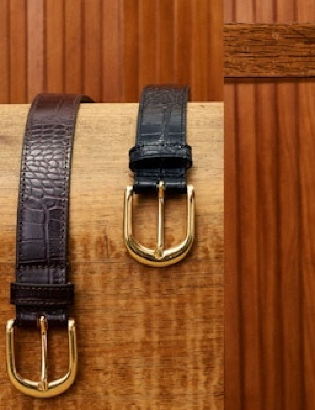 Two leather belts with gold buckles