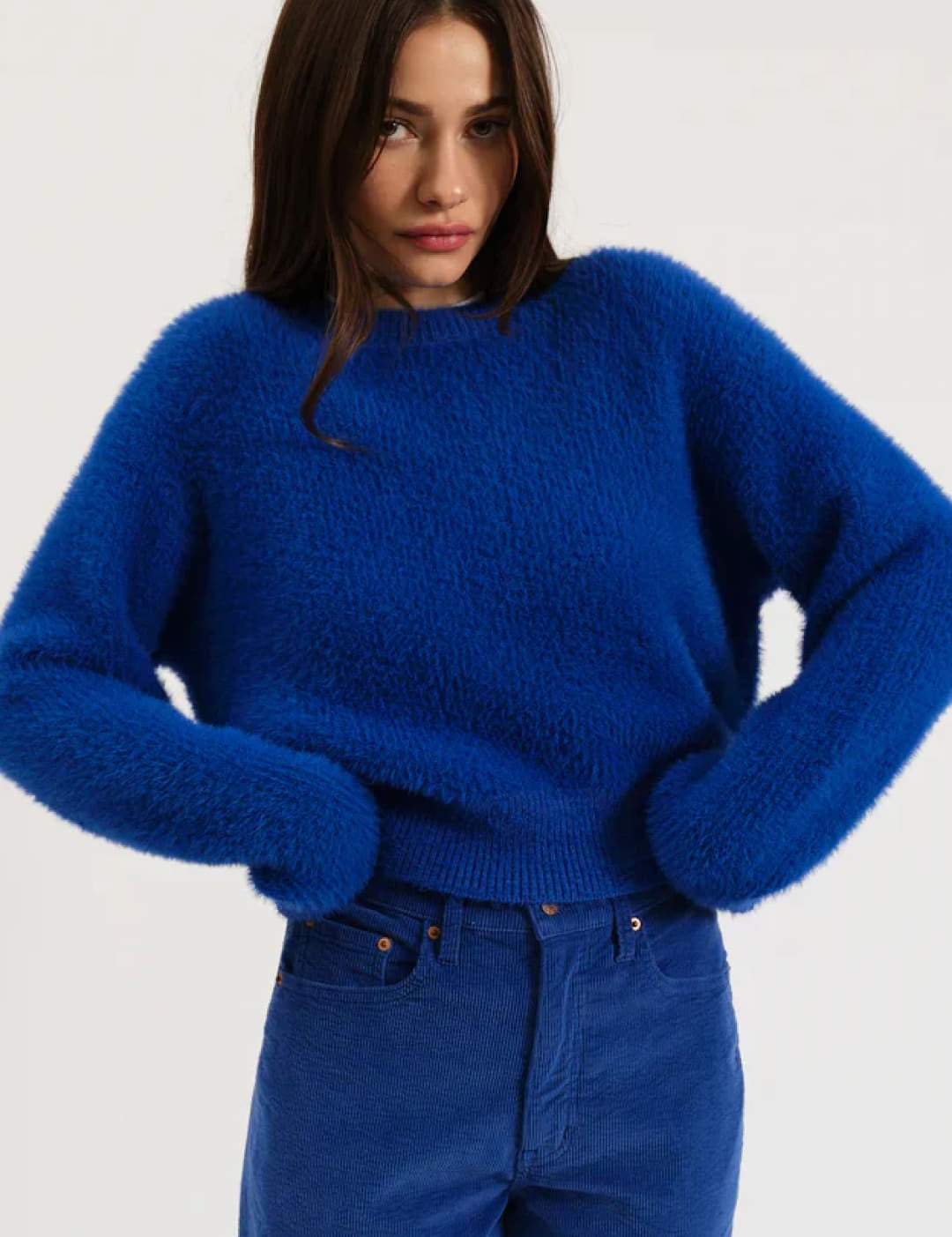 Royal blue fluffy sweater with long sleeves and round neckline.