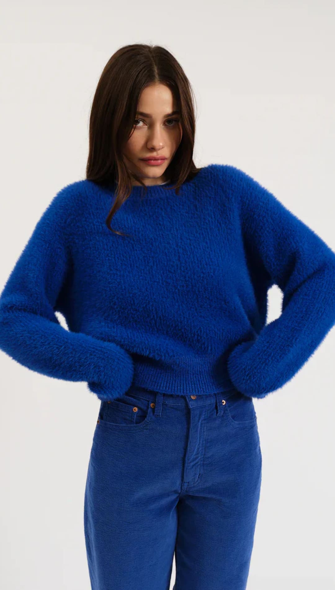 Royal blue fluffy sweater with long sleeves and round neckline.