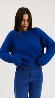 Royal blue fluffy sweater with long sleeves and round neckline.