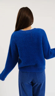 Royal blue fuzzy sweater with a relaxed fit and ribbed cuffs, inspired by mango’s casual wear collection.