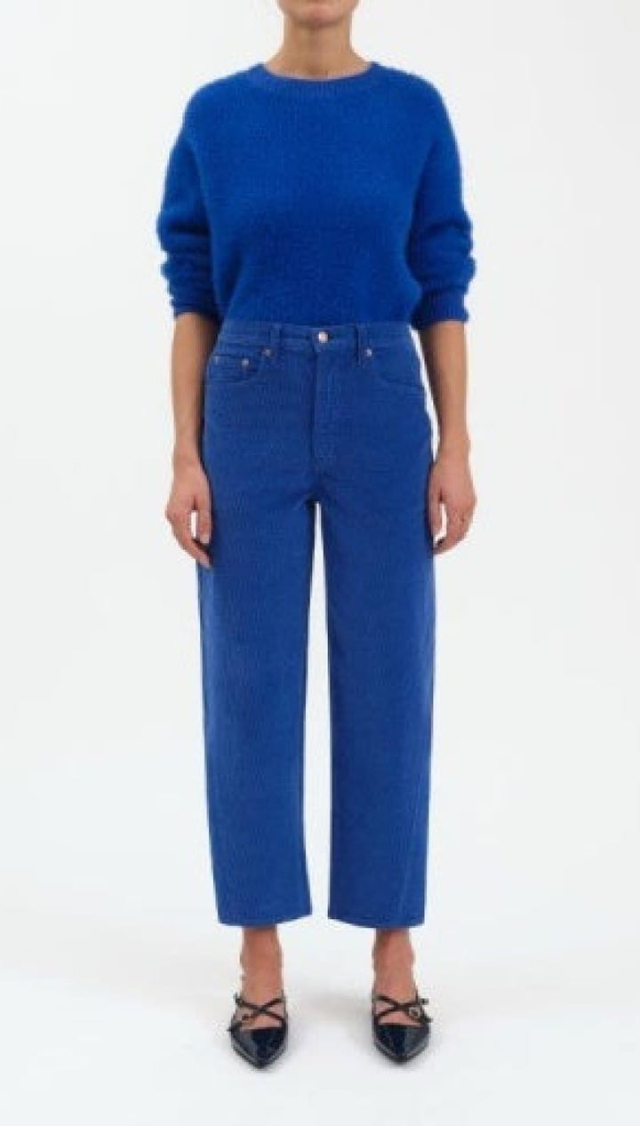 Royal blue high-waisted jeans with black lace-up heels.