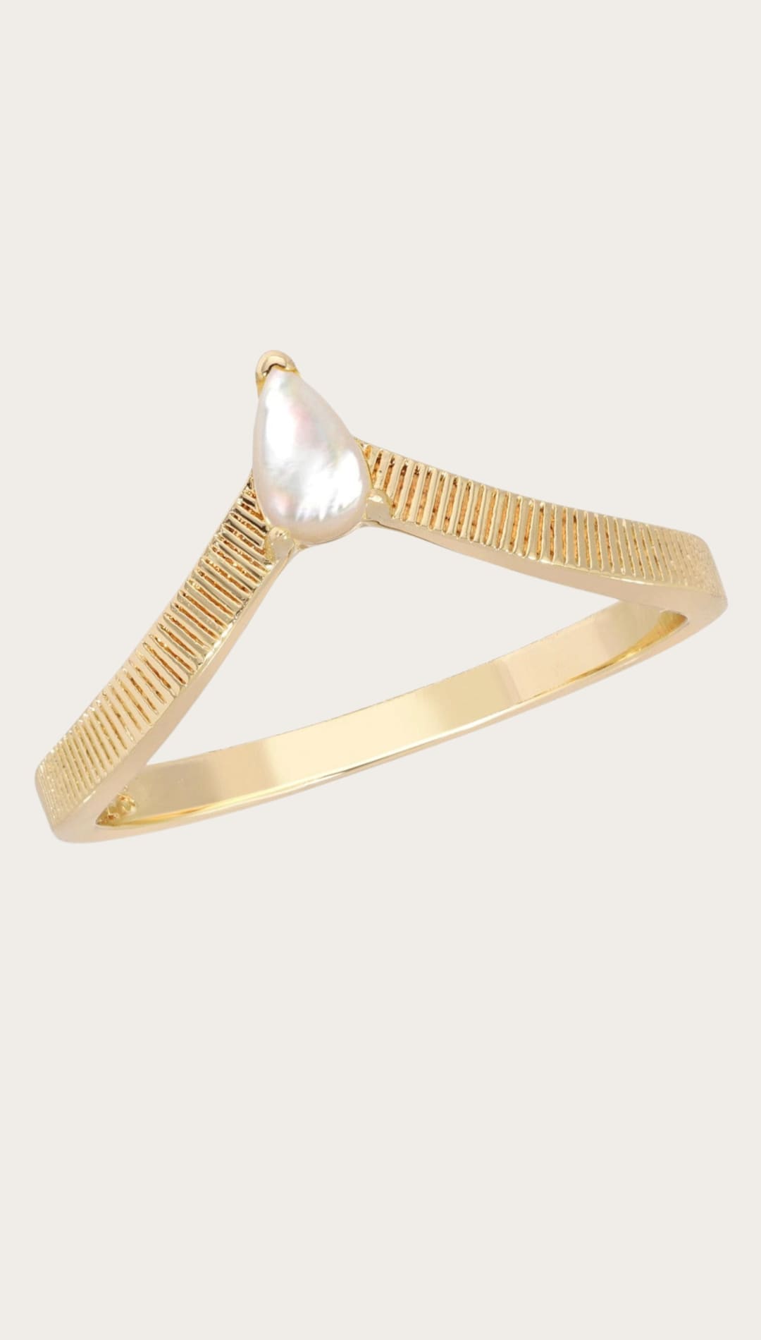 Gold chevron ring with pearlescent stone.