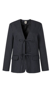 Dark pinstriped blazer with two front ties and two patch pockets.