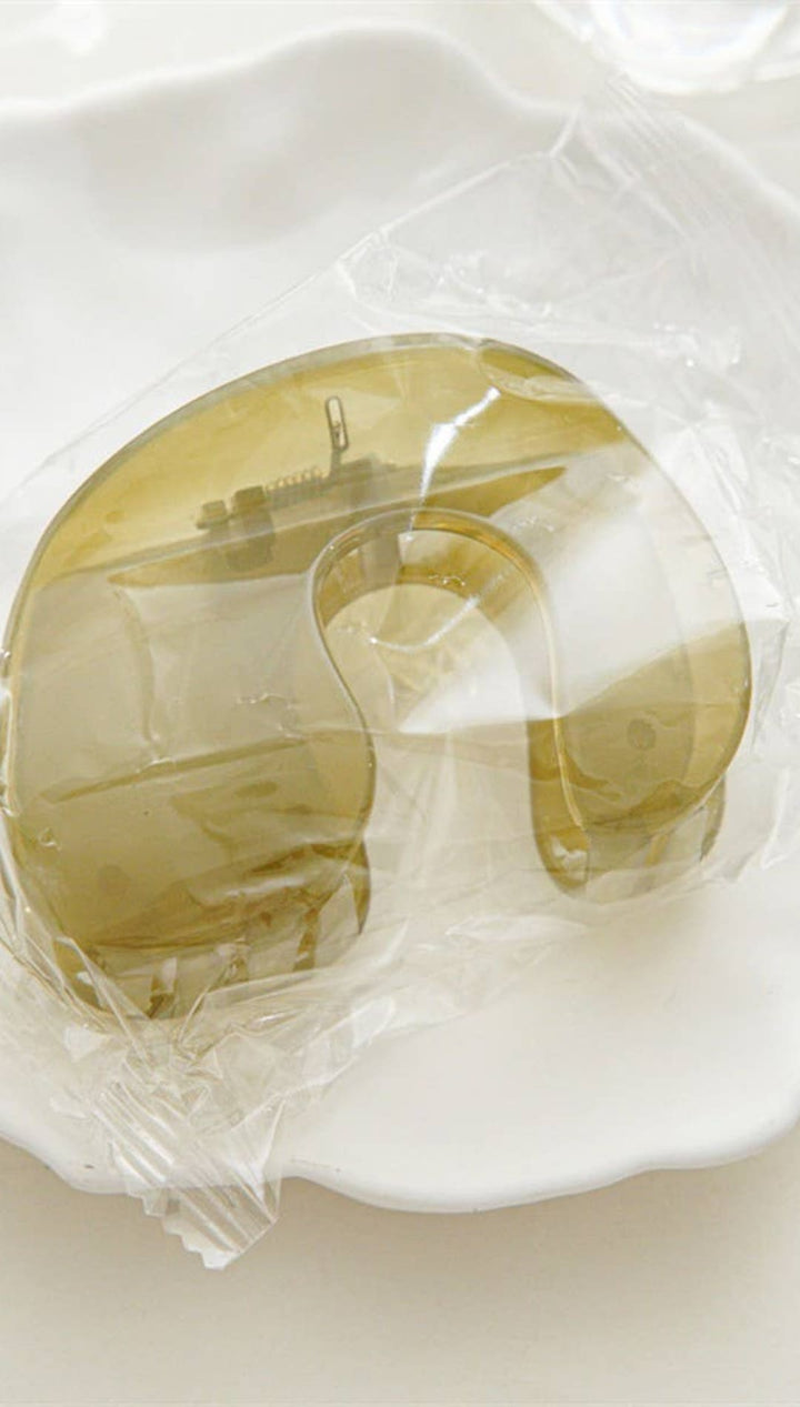 Gold apple-shaped soap bar with clear plastic wrapping.