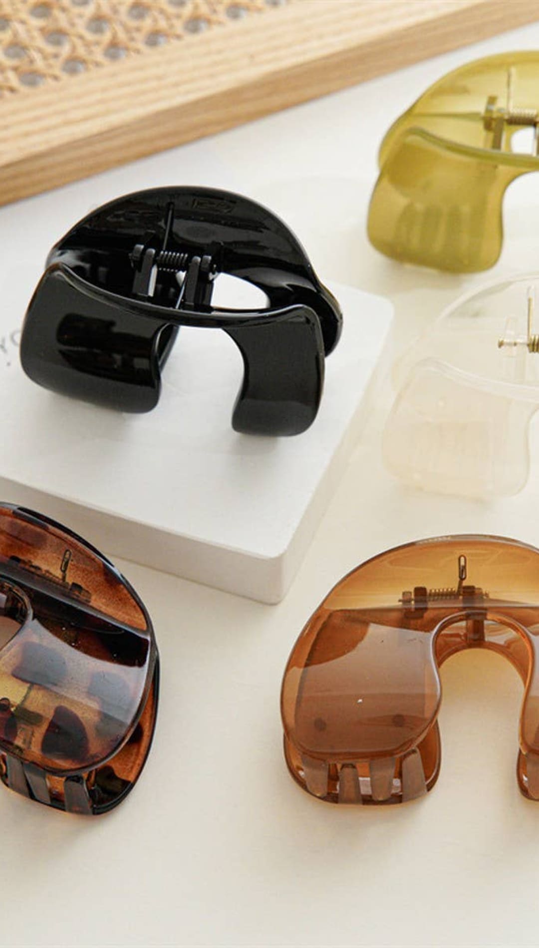 Tortoiseshell acrylic lip balm holder with black and brown hues, glossy finish.