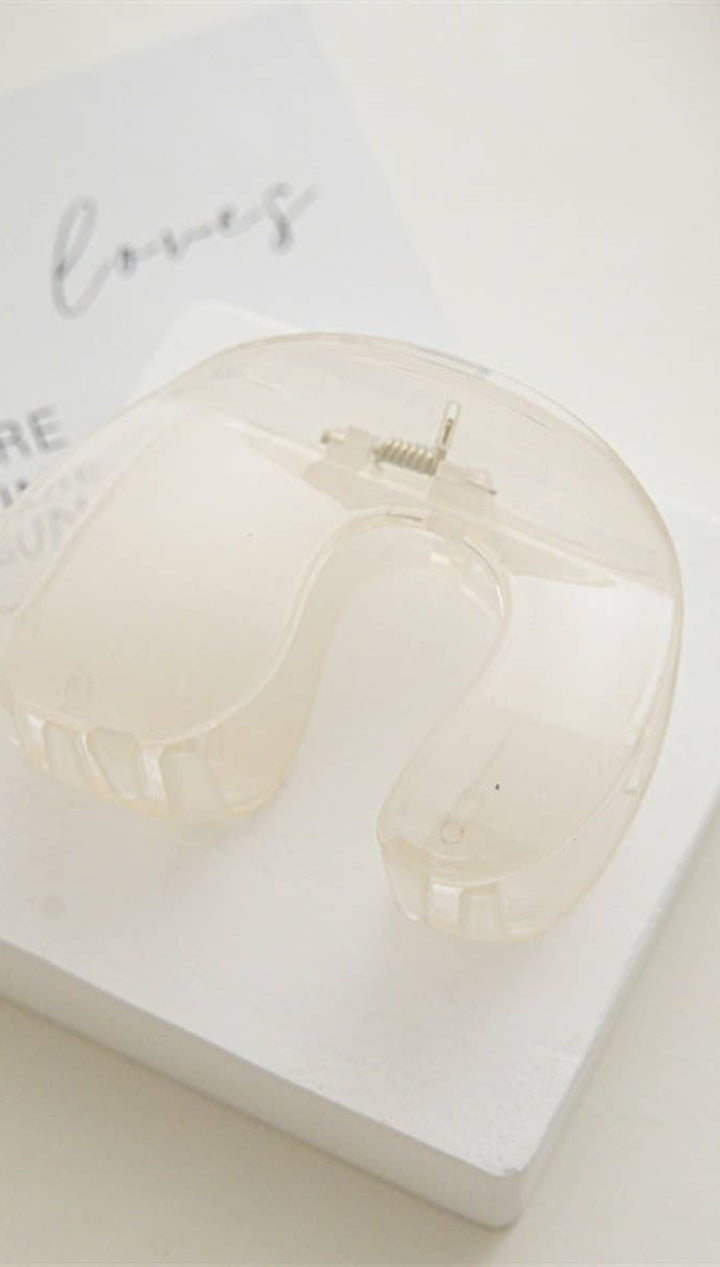 White skull-shaped candle holder with a clear glass top and silver accents.