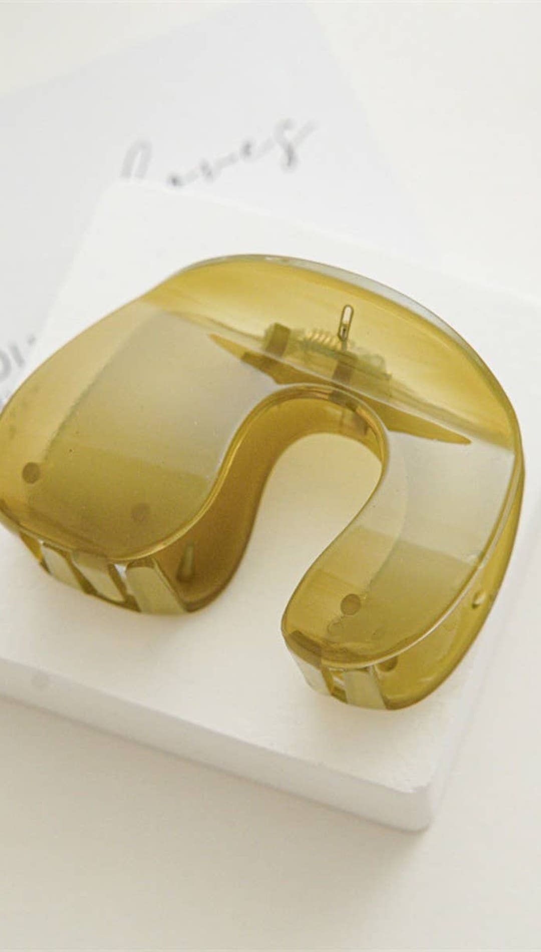 Gold-colored mouthguard with clear plastic accents and a sleek, modern design.
