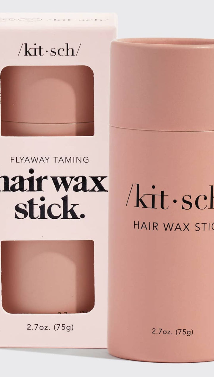 Pink hair wax stick with a sleek, matte finish and minimalist branding.