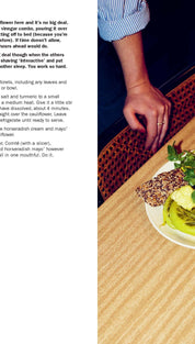 Green cauliflower salad with parsley and croutons on a white plate, served alongside a glass of red wine.