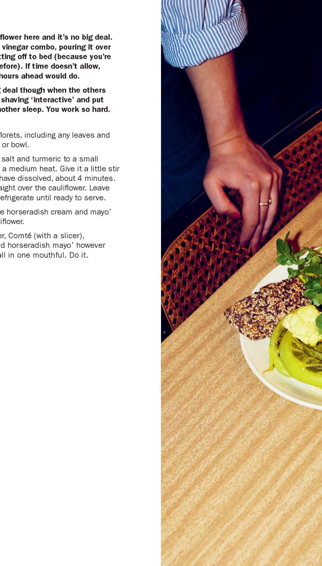 Green cauliflower salad with parsley and croutons on a white plate, served alongside a glass of red wine.