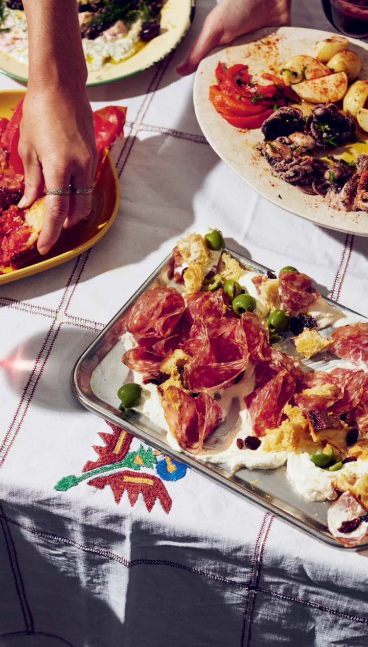 White and red patterned tablecloth with floral design